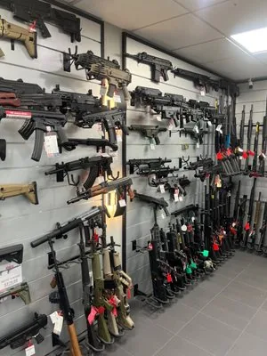 Wall-mounted rifle display at PJ Ammo