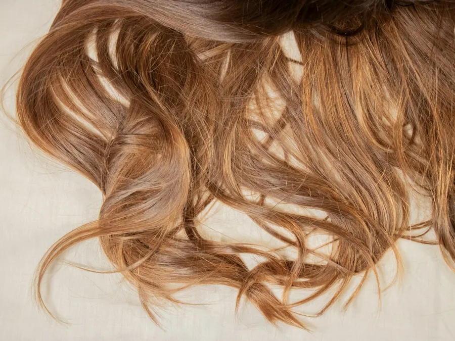Loose extension wefts laid out on a pale surface