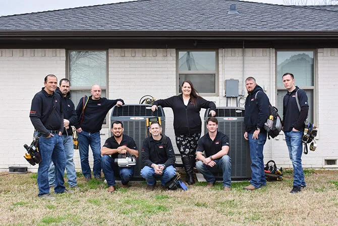 The Altus Air team of HVAC technicians gathered with their equipment outside a home