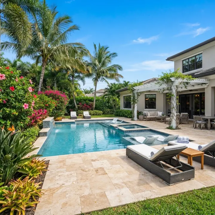 Poolside landscaping with tropical planting and privacy hedging