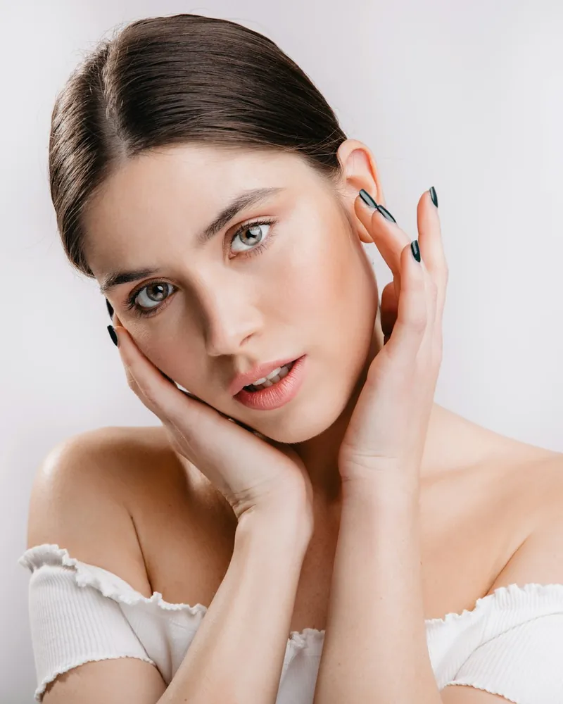 Portrait of a client resting her hands against her face