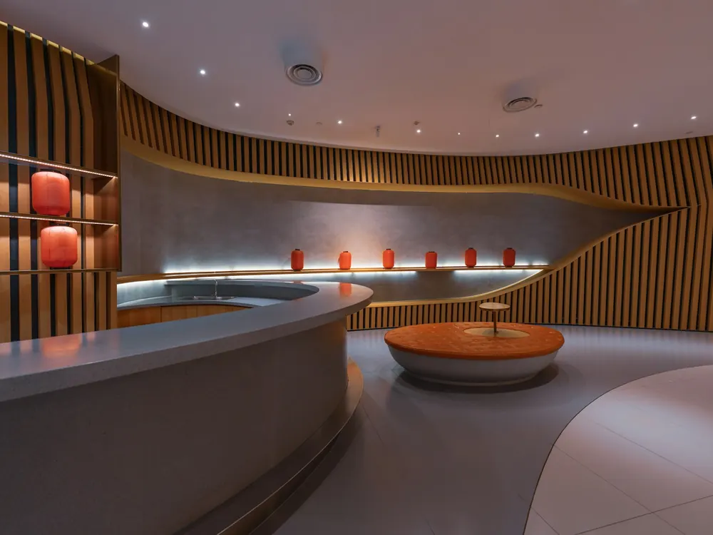 Curved warm-lit lounge area with recessed lighting