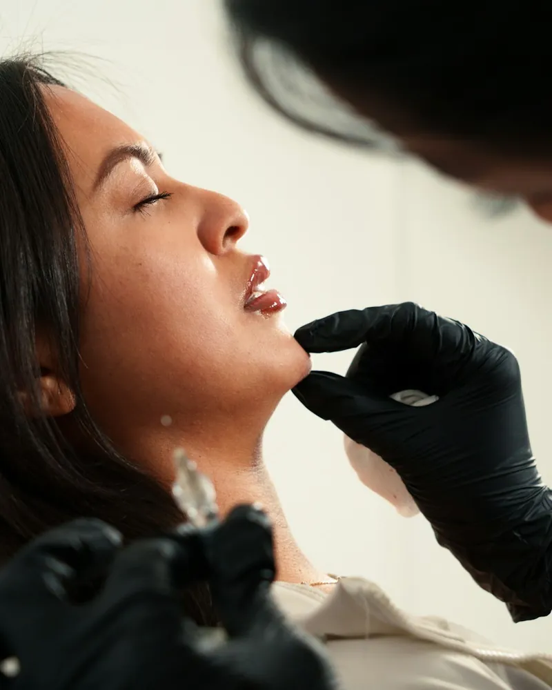 Practitioner performing a precise facial injectable treatment
