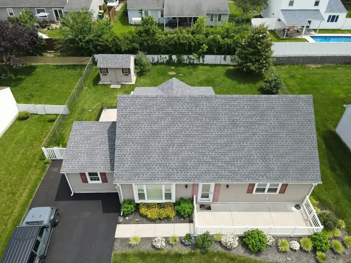 Aerial drone view of a suburban house roof during an inspection