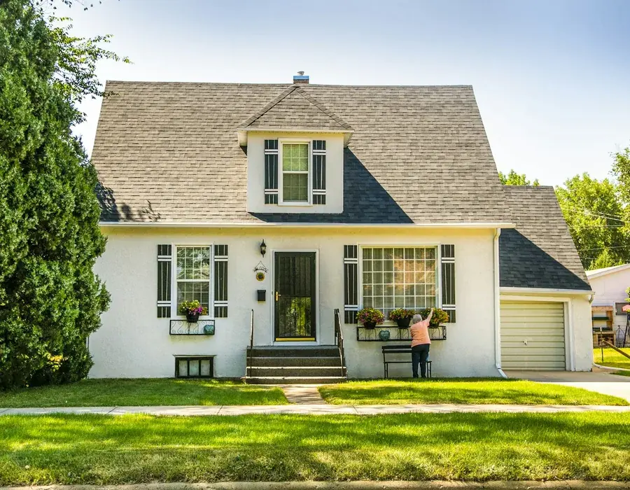 Cottage-style house with a replaced shingle roof and dormers