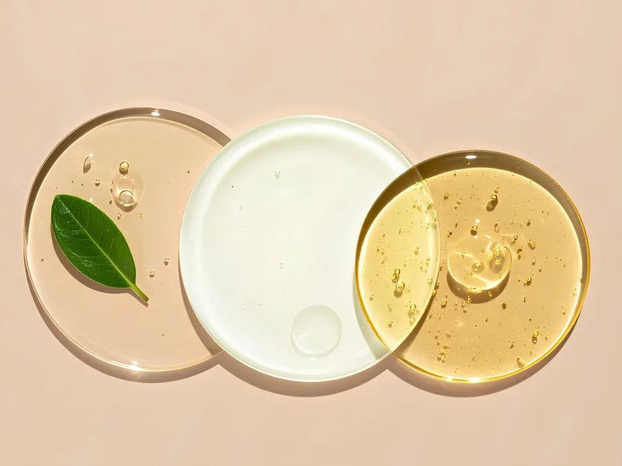 Skincare textures in glass dishes with botanical leaves