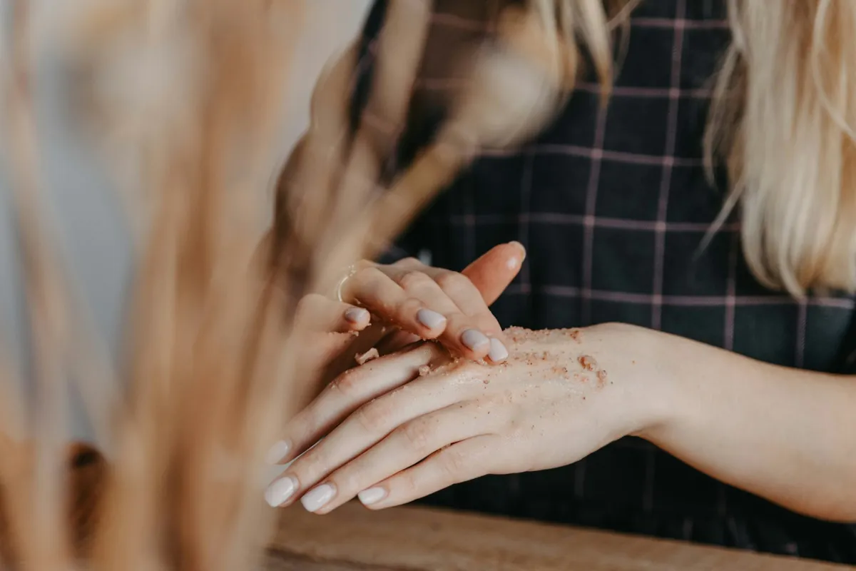 Close-up of an esthetician's hands working with product