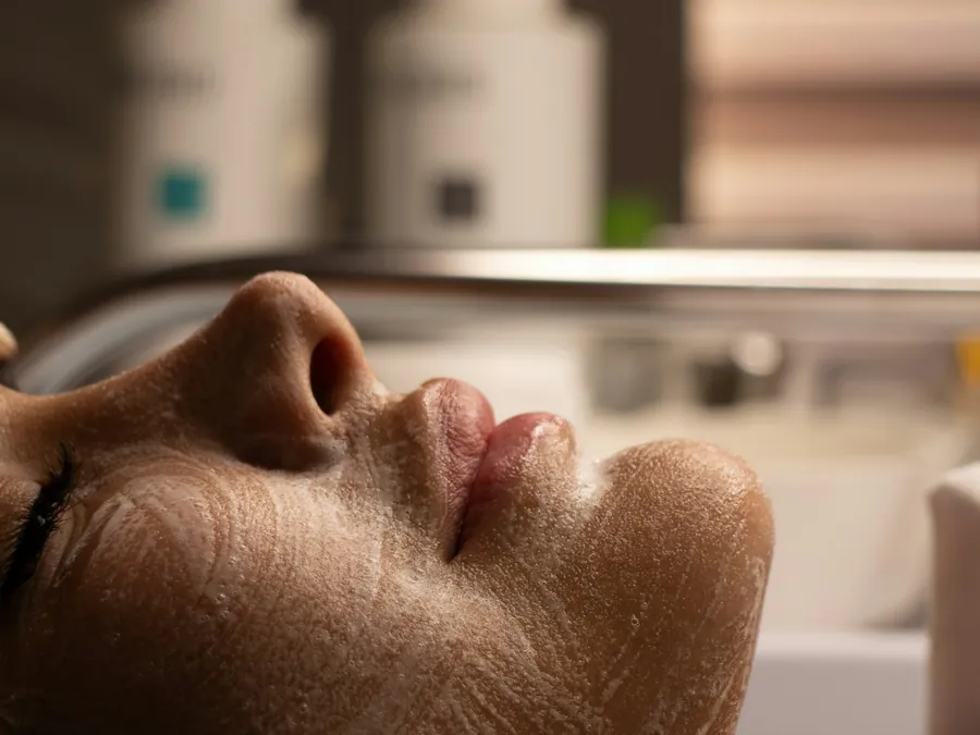 Client receiving a resurfacing treatment in a bright studio